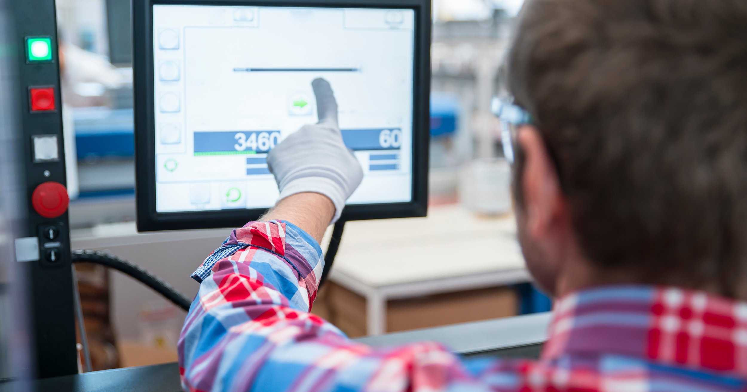 Employee reviewing data on the production line