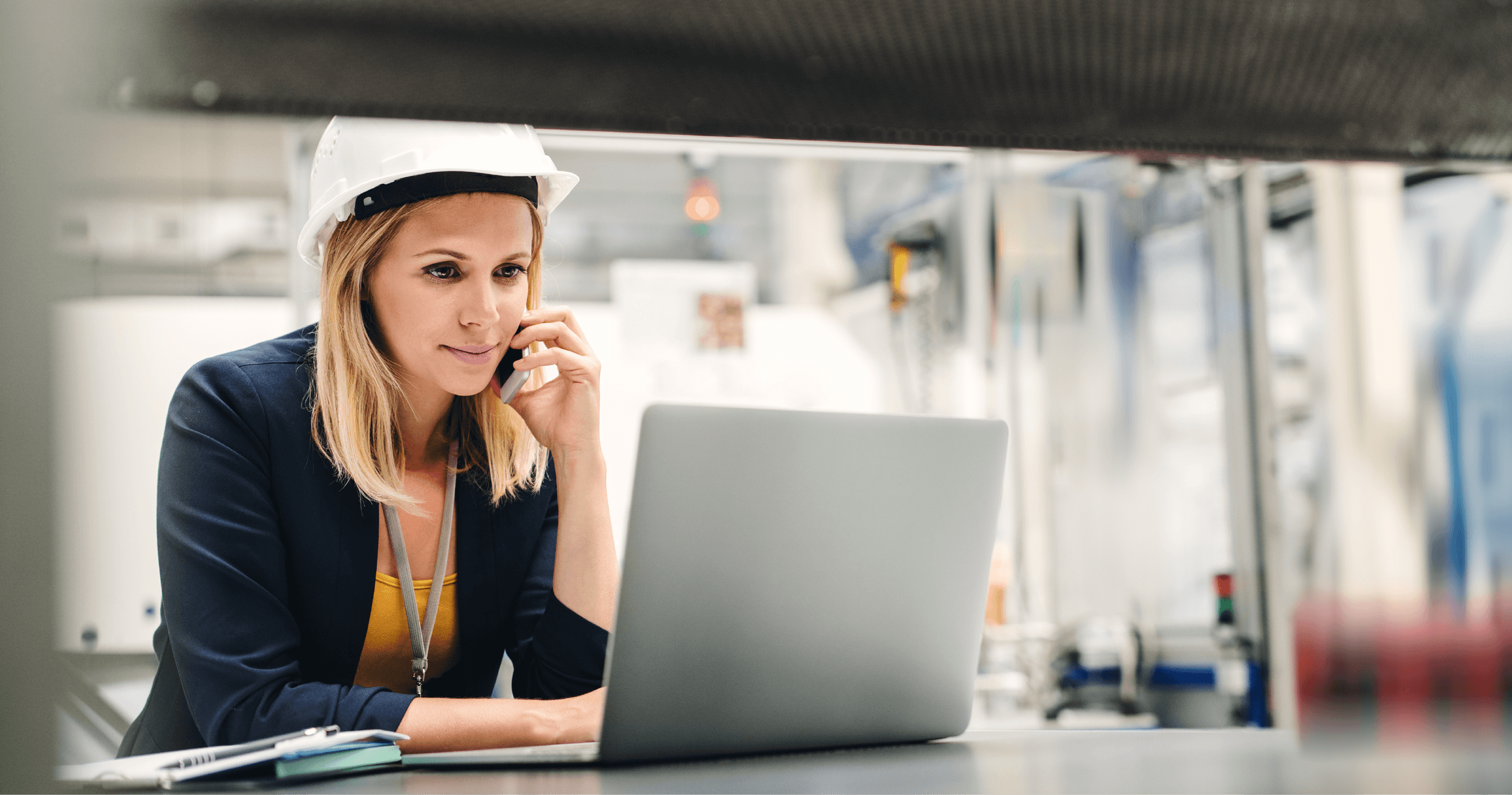 Woman using JDE on laptop in warehouse 